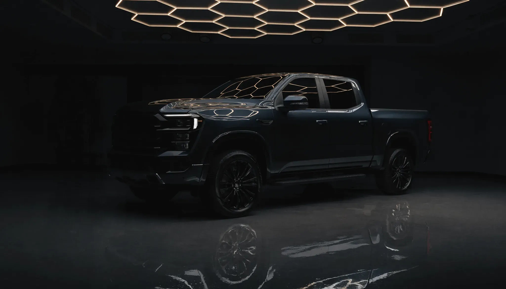 A blacked-out premium pickup truck with a deep ceramic-coated finish under studio lighting at JD Mobile Auto Detailing, Abbotsford